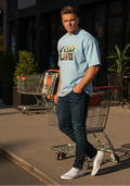 Man standing on a sidewalk with shopping carts, wearing a light blue t-shirt and dark jeans.