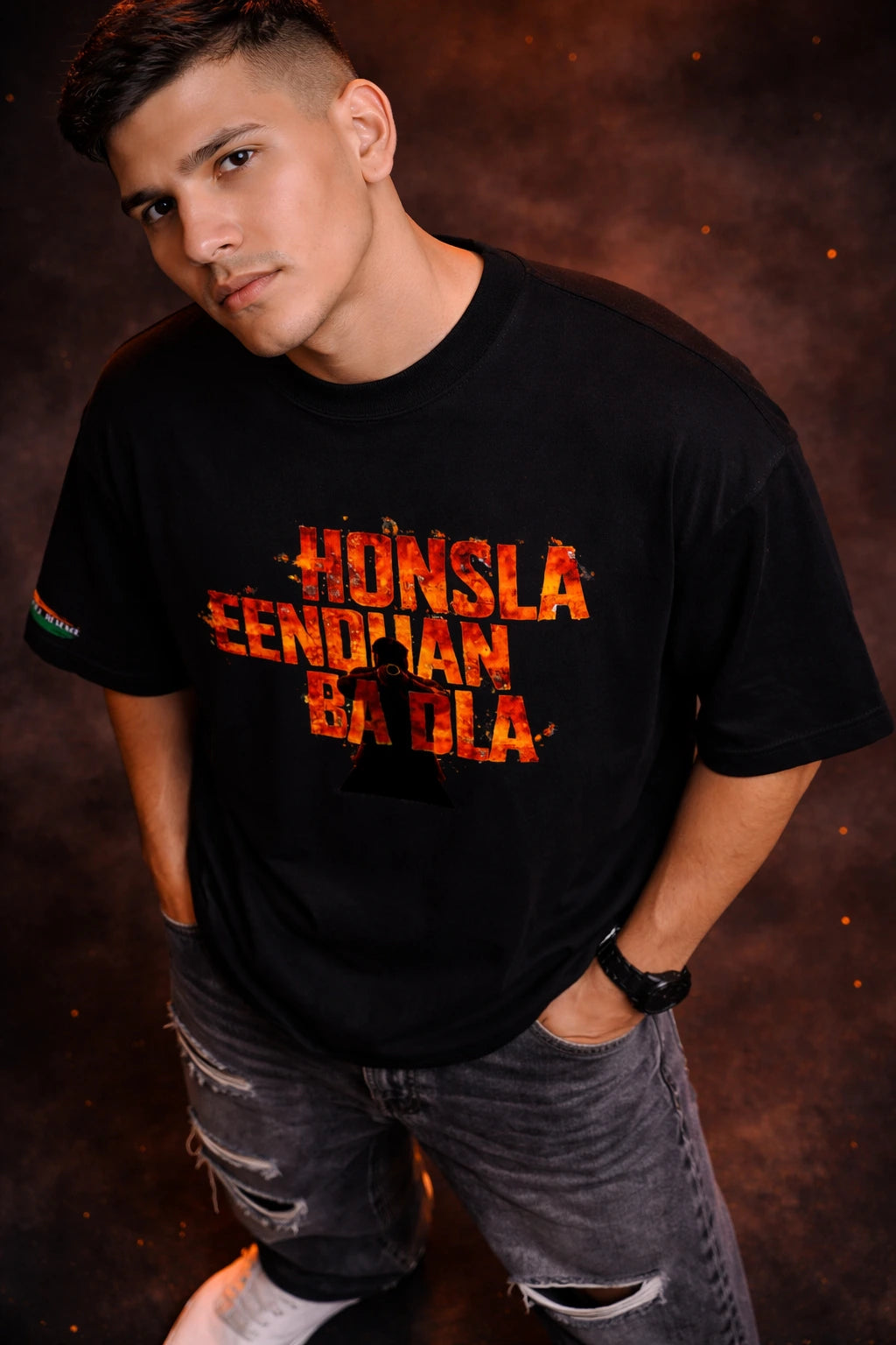 Person wearing a black t-shirt with colorful text against a dark background