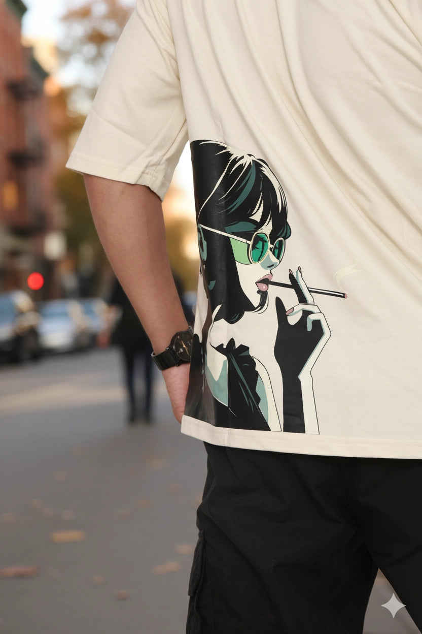 Person wearing a off white oversized t-shirt  with a graphic design of a woman smoking on a street.