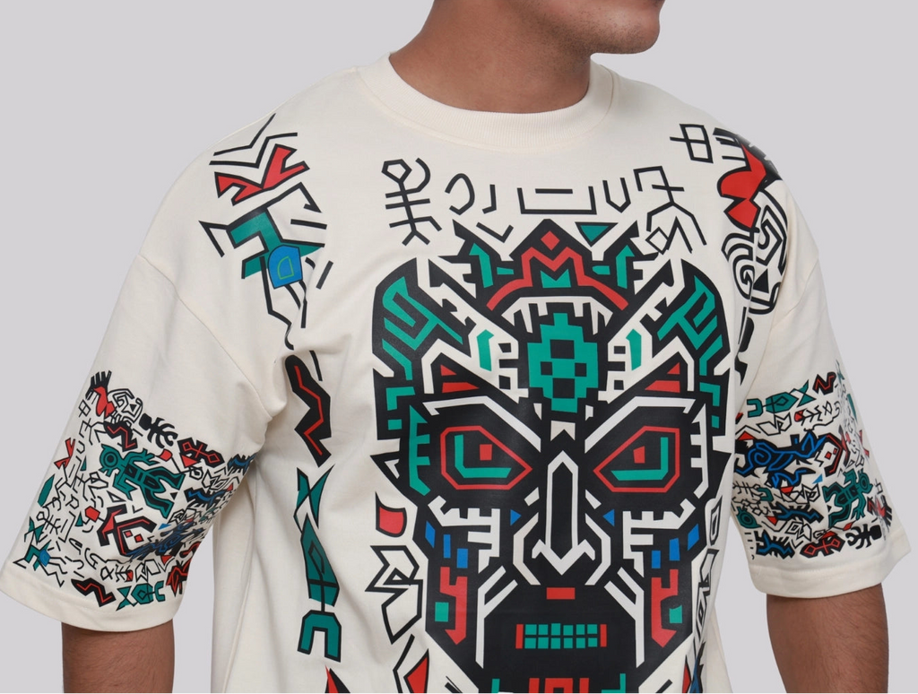 Person wearing a white hoodie with colorful geometric patterns on a plain background