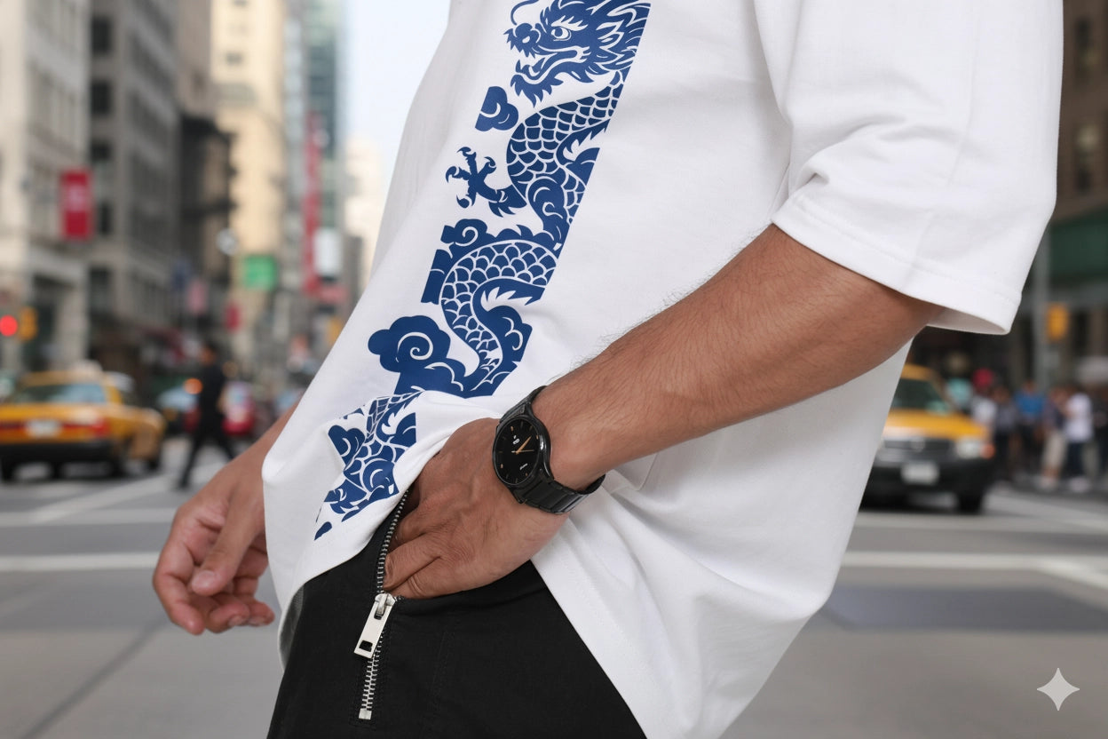 Person wearing a white shirt with blue dragon design oversized tshirt on a city street