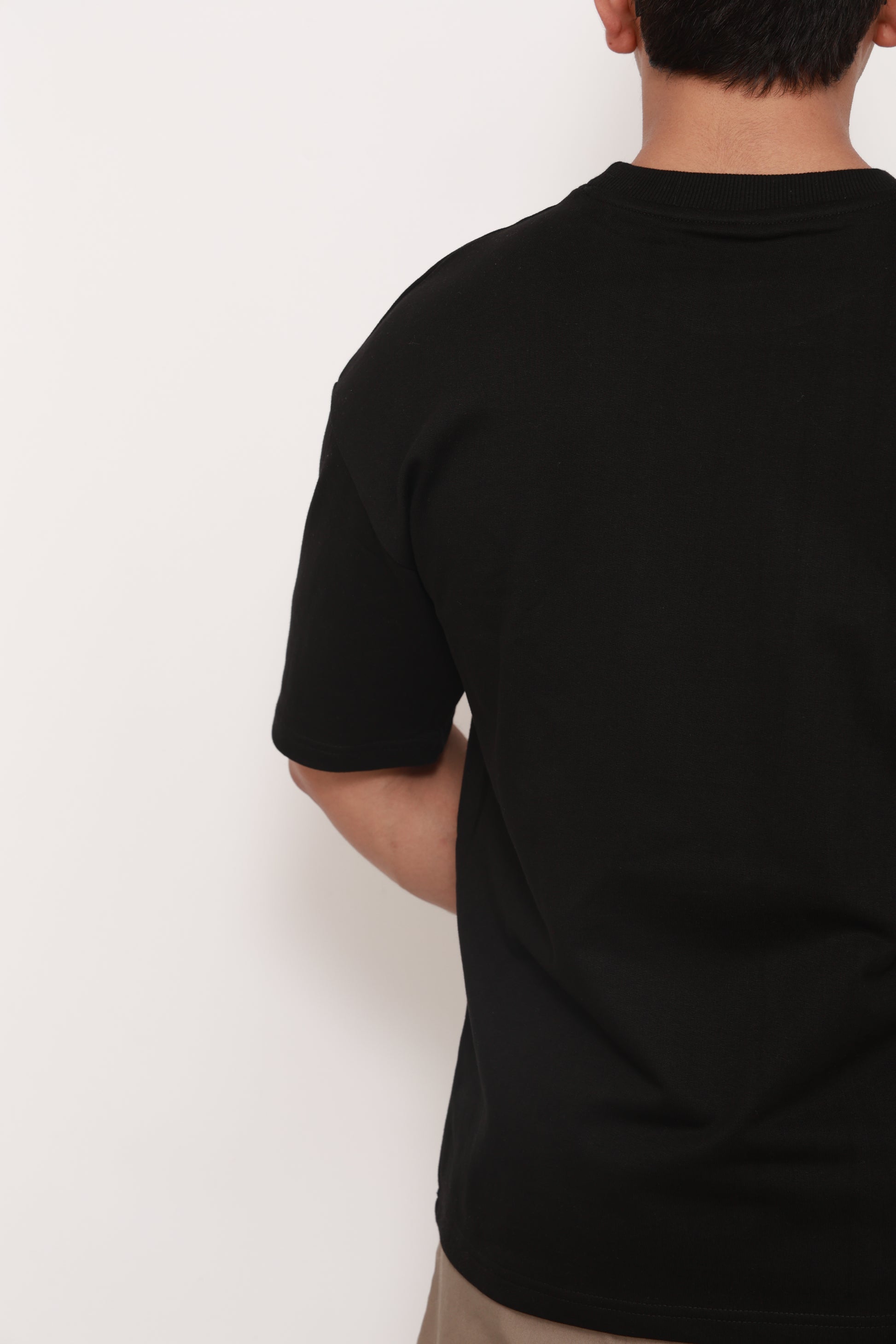Person wearing a Navy BlueTshirt with a colorful graphic design of an artistic camel 